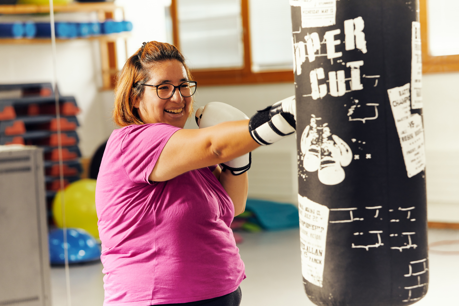 A woman punches a punch bag