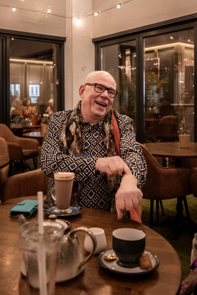 A man sitting with a coffee.
