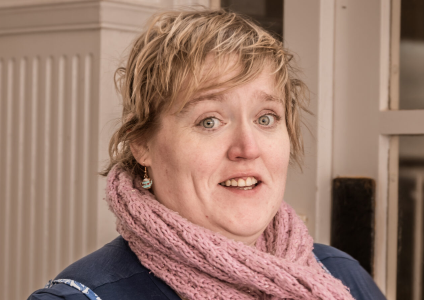 A woman wearing a pink scarf