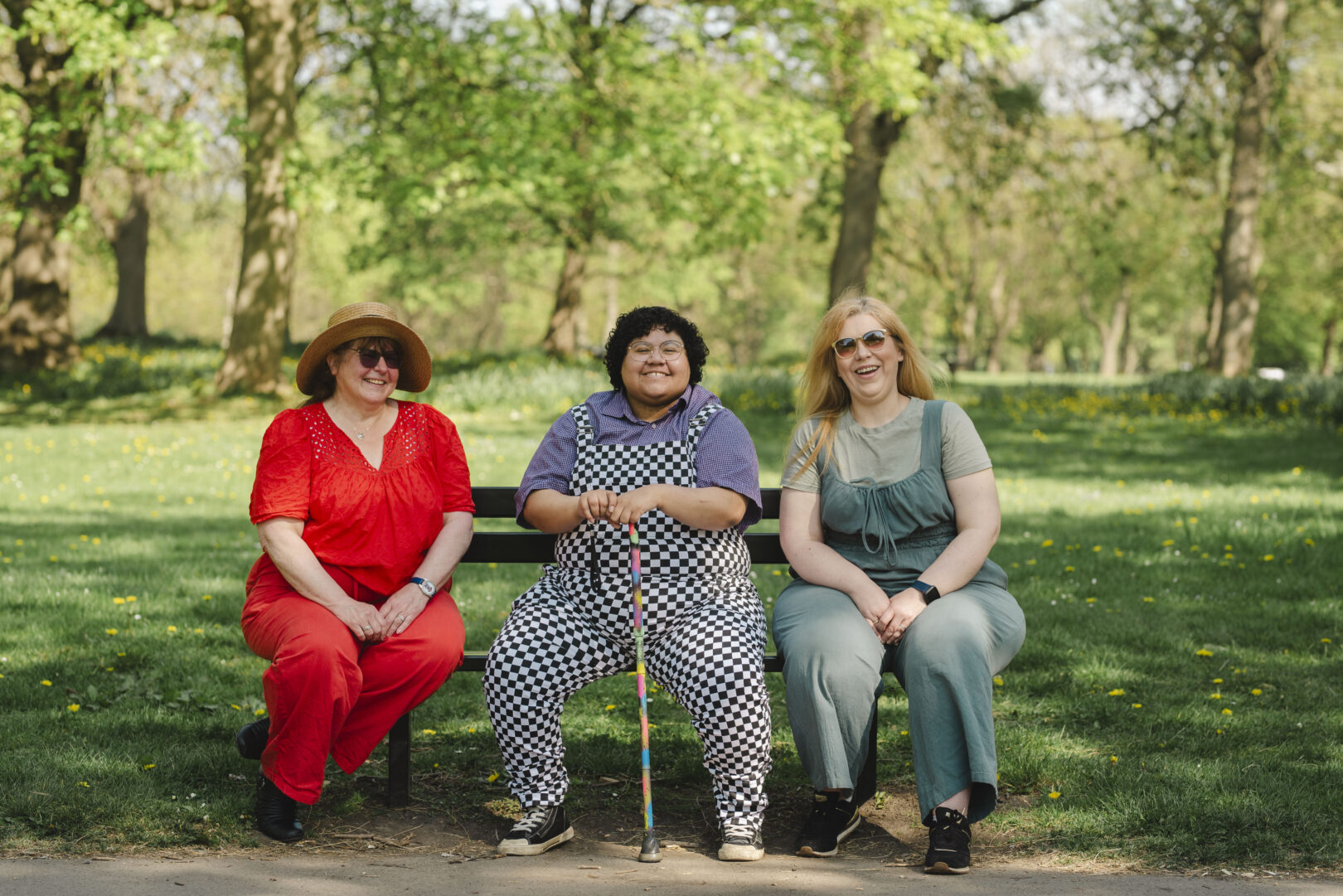 Three individuals in vibrant colours sitting on a bench on a sunny summers day. 

Image provided courtesy of Leeds Beckett University - leedsbeckett.ac.uk