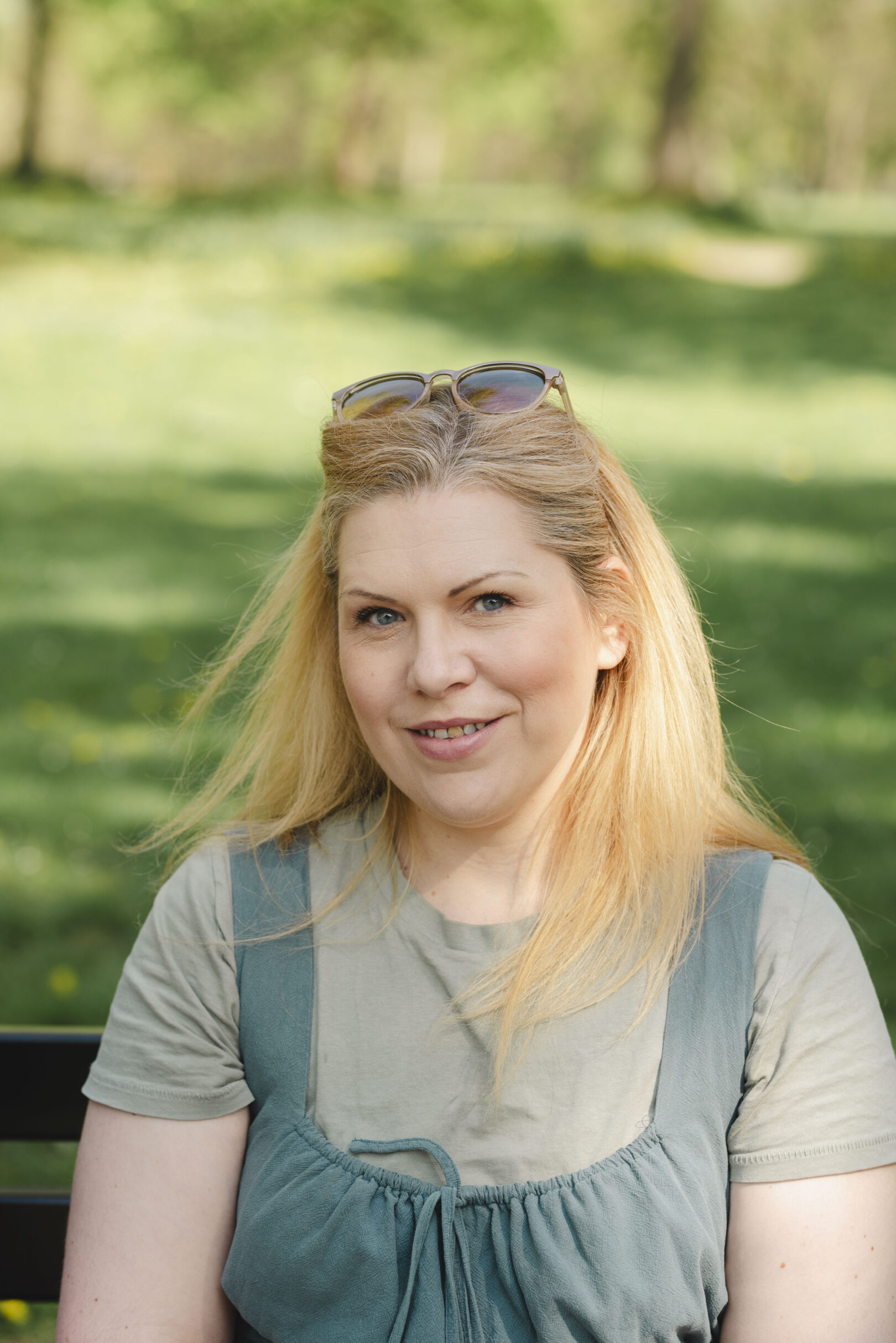 Person with long blond hair sitting on a park bench. Image provided courtesy of Leeds Beckett University - leedsbeckett.ac.uk