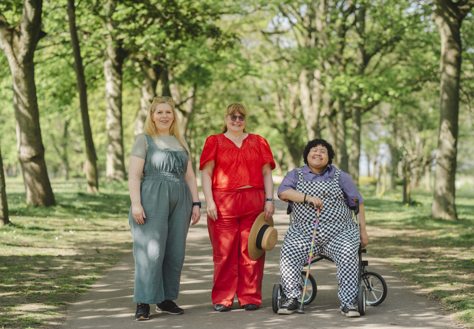 Three friends walking in a park on a sunny day. 