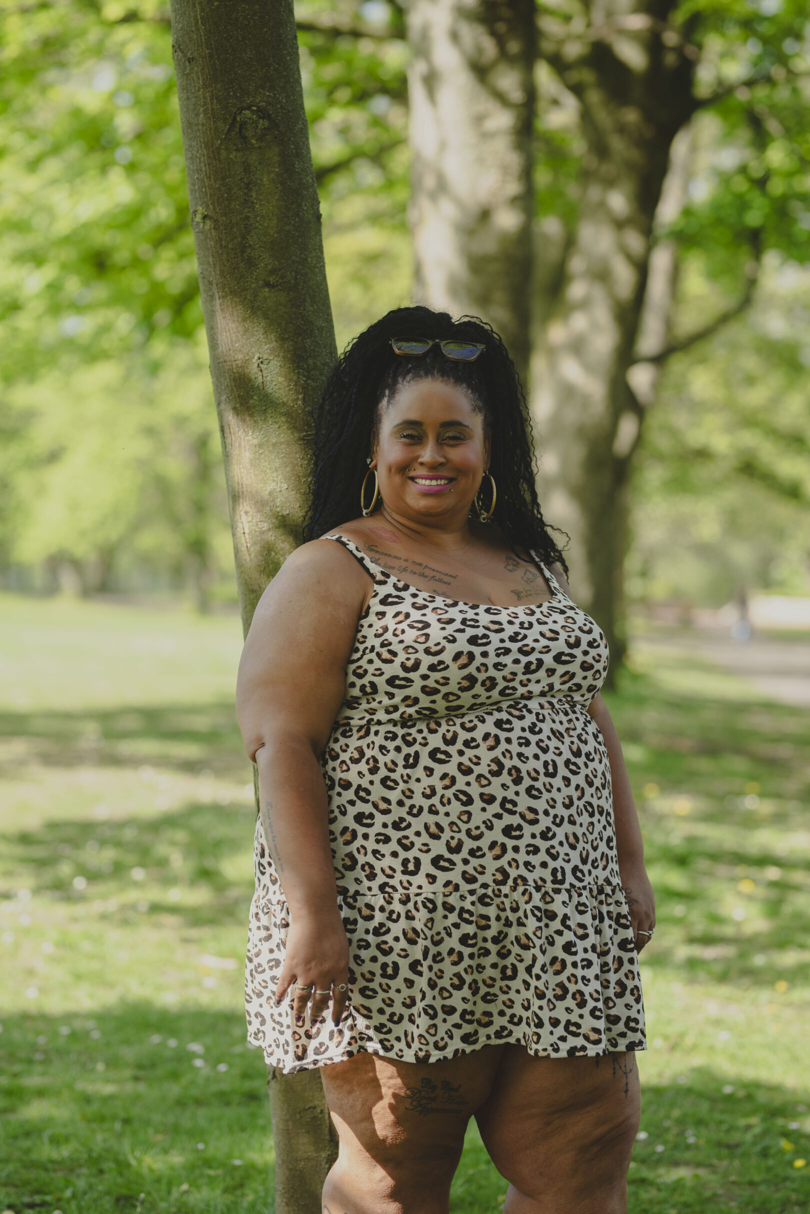 Person in leopard print dress standing on a park on a sunny day. Image provided courtesy of Leeds Beckett University - leedsbeckett.ac.uk